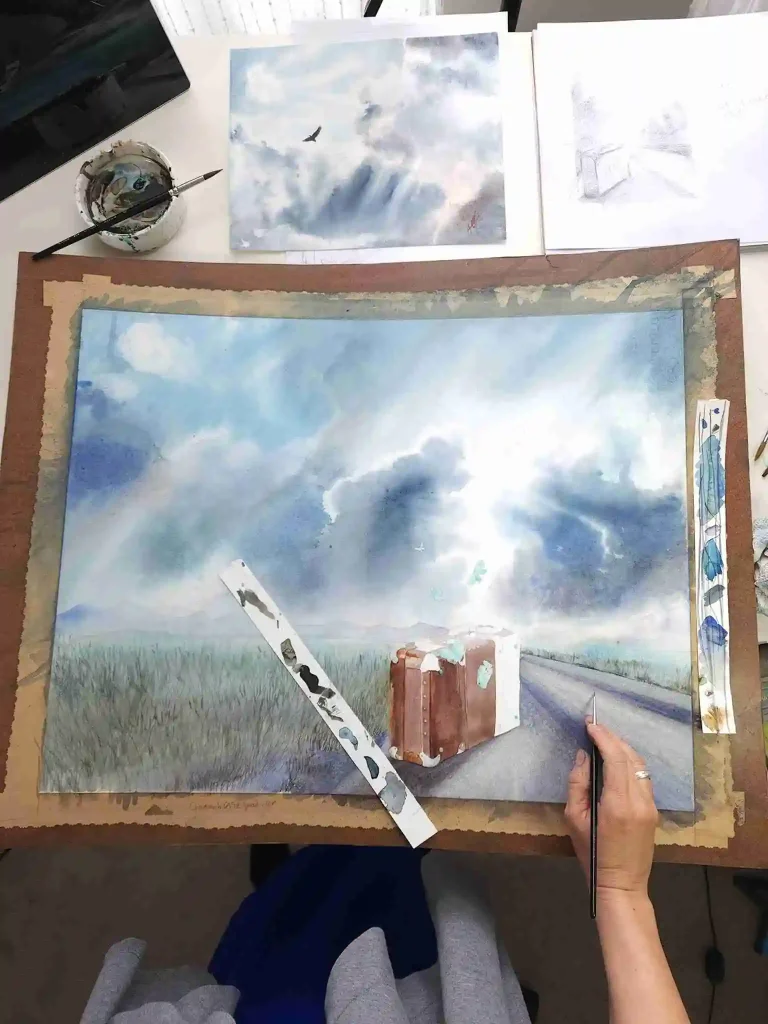 Painting of a the cover of Landed the book. This painting of a suitcase on a road under grey skies.